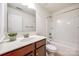 Clean, well-lit bathroom features a tub, shower, and vanity with cherry cabinets at 639 Stonehenge Dr, Rock Hill, SC 29730