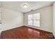 An empty bedroom with wood floors and natural light from the window at 639 Stonehenge Dr, Rock Hill, SC 29730