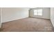 Large bedroom with neutral carpet and window at 639 Stonehenge Dr, Rock Hill, SC 29730