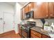 This modern kitchen features a black range, granite countertops, and wooden cabinets at 639 Stonehenge Dr, Rock Hill, SC 29730