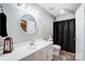 Clean bathroom with white vanity and black shower curtain at 1500 Beth Haven Church Rd, Denver, NC 28037
