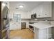Modern kitchen with white cabinets, stainless steel appliances, and tile floor at 1500 Beth Haven Church Rd, Denver, NC 28037