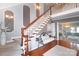 Elegant two-story entryway with hardwood floors, staircase, and bench at 4723 Old Mountain Rd, Stony Point, NC 28678