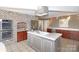 Modern kitchen with double oven, brick accent wall, and island at 4723 Old Mountain Rd, Stony Point, NC 28678