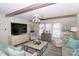 Relaxing living room with a fireplace, ceiling fan, and comfy seating at 4723 Old Mountain Rd, Stony Point, NC 28678