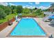 Relaxing inground pool with slide, brick wall, and patio furniture at 4723 Old Mountain Rd, Stony Point, NC 28678