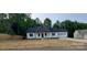 Charming home featuring white siding, a dark roof, and an attached garage nestled amongst mature trees at 536 Robinhood Rd # 27, Maiden, NC 28650