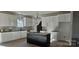 Modern kitchen with black countertops, a black kitchen island and white cabinetry at 536 Robinhood Rd # 27, Maiden, NC 28650