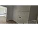 Neutral toned laundry room with wire rack installed and view to the kitchen at 536 Robinhood Rd # 27, Maiden, NC 28650