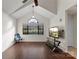 Living room featuring hardwood floors, vaulted ceiling and TV stand at 200 W 18Th St, Newton, NC 28658