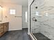 Beautiful bathroom with modern shower, double vanity with wood cabinets and tile flooring at 5676 Clear Creek Ln, Charlotte, NC 28215