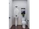 Charming powder room featuring a pedestal sink, stylish mirror, and modern black fixtures at 5676 Clear Creek Ln, Charlotte, NC 28215