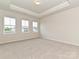 Bright bedroom with tray ceiling, large windows providing ample natural light at 5676 Clear Creek Ln, Charlotte, NC 28215