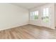Versatile bonus room with natural light, hardwood floors, and outdoor access at 5676 Clear Creek Ln, Charlotte, NC 28215