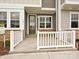 Inviting front porch with stone accents and a white railing creates curb appeal at 5676 Clear Creek Ln, Charlotte, NC 28215