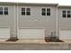 Exterior view of garages on a townhome with siding at 5676 Clear Creek Ln, Charlotte, NC 28215
