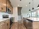 Well-equipped kitchen with stainless steel appliances, stone countertops, and wooden cabinets at 5676 Clear Creek Ln, Charlotte, NC 28215