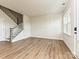 Bright living area featuring hardwood floors and a staircase leading to the upper level at 5676 Clear Creek Ln, Charlotte, NC 28215