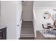Carpeted staircase leading to the upper level, with a view of the dining area at 5676 Clear Creek Ln, Charlotte, NC 28215