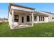 Rear view of home with a covered patio and grassy backyard at 7169 Chamberlain Dr, Harrisburg, NC 28075