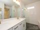 Modern bathroom with dual sinks, a glass shower, and sleek finishes for a contemporary look at 7169 Chamberlain Dr, Harrisburg, NC 28075