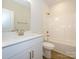 Bright bathroom with white vanity, gold hardware, and tub-shower combo at 7169 Chamberlain Dr, Harrisburg, NC 28075