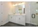 Bright bathroom featuring double sinks, white cabinetry, and a glass-enclosed shower for a spa-like experience at 7169 Chamberlain Dr, Harrisburg, NC 28075