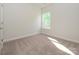 Light and airy bedroom featuring a window with bright light at 7169 Chamberlain Dr, Harrisburg, NC 28075