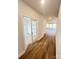 Bright hallway featuring hardwood floors and a beautiful french door leading into another room at 7169 Chamberlain Dr, Harrisburg, NC 28075