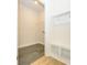 Well-lit mudroom area with hooks, bench, and view into laundry room at 7169 Chamberlain Dr, Harrisburg, NC 28075