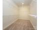 Spacious walk-in closet equipped with ample shelving and storage solutions to maximize organization at 7169 Chamberlain Dr, Harrisburg, NC 28075