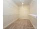 Spacious walk-in closet features wire shelving and neutral carpeting at 7169 Chamberlain Dr, Harrisburg, NC 28075