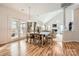 Open dining area with hardwood floors and access to sunroom at 2240 Dunnwood Hills Dr, Matthews, NC 28105
