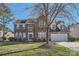 Brick two-story house with a large front yard and attached garage at 2240 Dunnwood Hills Dr, Matthews, NC 28105