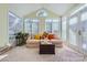 Bright sunroom with windows and comfortable seating at 2240 Dunnwood Hills Dr, Matthews, NC 28105