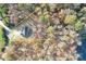 Aerial shot showcasing property's boundaries on wooded lot with house and pond at 3146 Captains Cove Ln, Lincolnton, NC 28092