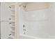 Clean bathroom with a shower-tub combo and built-in shelving for storage at 3146 Captains Cove Ln, Lincolnton, NC 28092