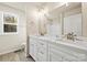 Bright bathroom featuring a double vanity with modern fixtures and a marble countertop at 3146 Captains Cove Ln, Lincolnton, NC 28092
