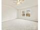 Spacious bedroom features a vaulted ceiling, carpeted floors, a ceiling fan, and a large window at 3146 Captains Cove Ln, Lincolnton, NC 28092
