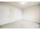 Bedroom featuring neutral carpet, a double-door closet, and white walls at 3146 Captains Cove Ln, Lincolnton, NC 28092