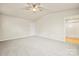 Spacious bedroom has carpeted floors, a ceiling fan, and ensuite bathroom at 3146 Captains Cove Ln, Lincolnton, NC 28092