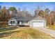 Charming single-story home with a two-car garage and a well-manicured lawn, all under a clear, sunny sky at 3146 Captains Cove Ln, Lincolnton, NC 28092