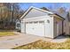 Spacious two-car garage with ample parking space and adjacent landscaping at 3146 Captains Cove Ln, Lincolnton, NC 28092