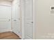 Hallway with wood flooring and white doors at 3146 Captains Cove Ln, Lincolnton, NC 28092
