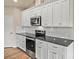 Beautiful kitchen features new stainless steel appliances, granite countertops, and modern white cabinets at 3146 Captains Cove Ln, Lincolnton, NC 28092