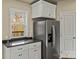 Kitchen features stainless steel refrigerator, granite countertops, and modern white cabinets at 3146 Captains Cove Ln, Lincolnton, NC 28092