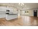 Open-concept kitchen features white cabinetry, a center island, and new stainless steel appliances at 3146 Captains Cove Ln, Lincolnton, NC 28092