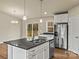 Kitchen features stainless steel appliances, granite countertops, and an island with sink at 3146 Captains Cove Ln, Lincolnton, NC 28092