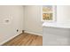 The laundry room features wood-look flooring, and plenty of natural light at 3146 Captains Cove Ln, Lincolnton, NC 28092