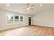 Bright living room featuring wood floors, large windows, ceiling fan, and neutral paint at 3146 Captains Cove Ln, Lincolnton, NC 28092